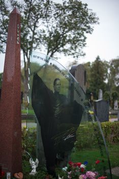 VIENNA - OCTOBER 7: Memorial at Falco’s grave in Zentralfriedhof (Central Cemetery) on October 7, 2012 in Vienna, Austria. Falco was an Austrian pop singer, rapper and musician. His hit single “Rock me Amadeus” was the first and so far only song in German language that ever hit the US Billboard charts. Falco died 1998 in the Dominican Republic and was buried in his home town Vienna, where still many fans pay their respect by visiting his grave every day.