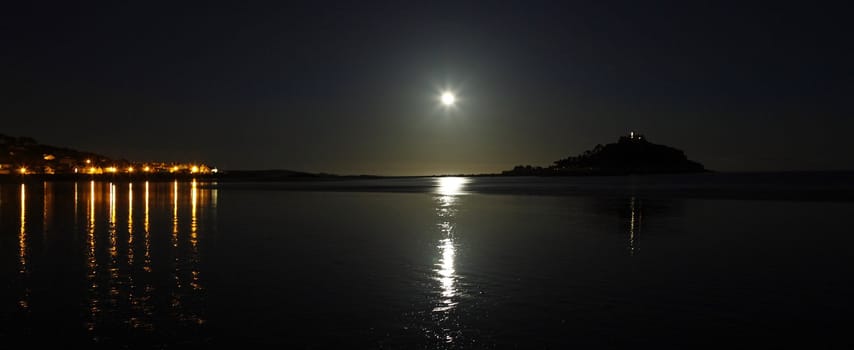 Night shot in the South of England with the moon reflecting on the still sea