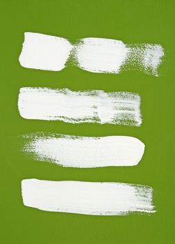 White brush strokes on bright green background.