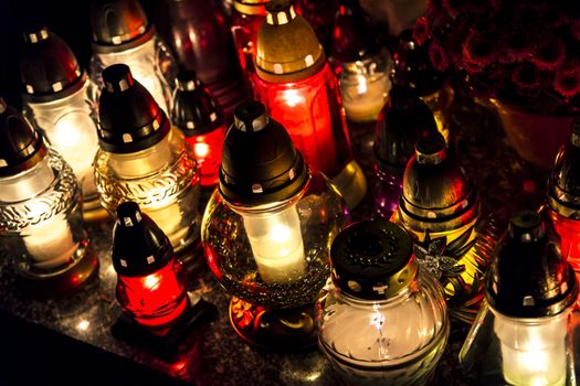 All Saints' Day at a cemetery in Poland - flowers and light candles to honor the memory of deceased relatives.