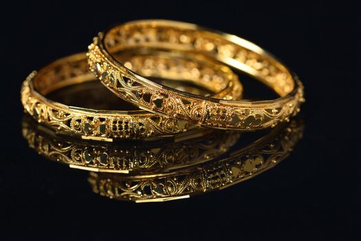 Beautiful golden bangles isolated on black backround