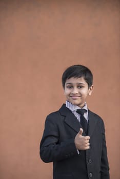 Portrait of a Handsome Little Boy in a Business Suit