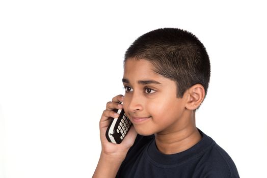 Handsome Indian kid looking very happy talking on phone