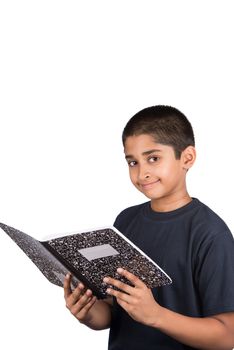 An handsome Indian kid doing his homework diligently