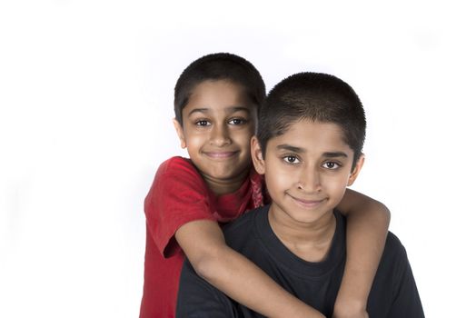 Indian brothers smiling happily against a white background