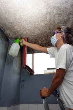 woman sprayed with detergent against mildew