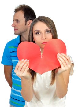 Attractive young girl holding broken paper red valentine heart