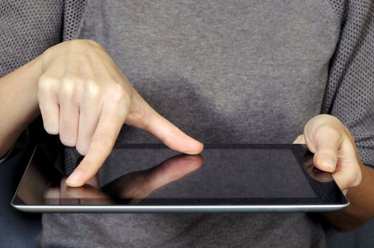 Woman hand on tablet screen