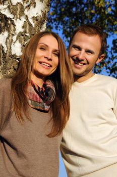 Young couple under a tree in autumn