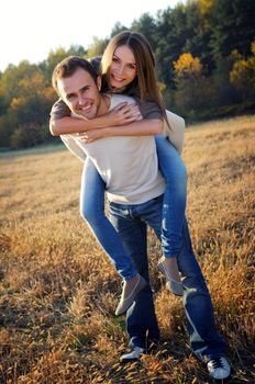 Young couple playing in fall