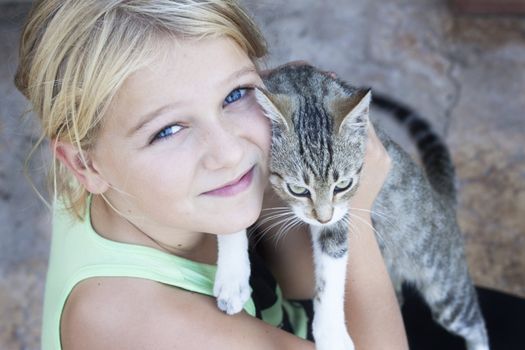 A pretty girl holding an angry looking cat
