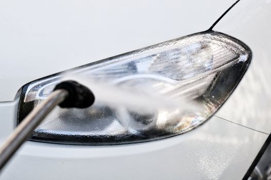 Washing a car lamp at carwash