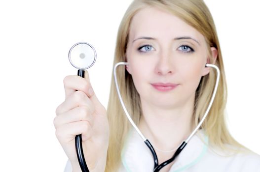 Smiling doctor in white coat using stethoscope isolated