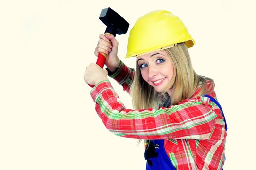 Young woman with helmet and hammer trying to hit something
