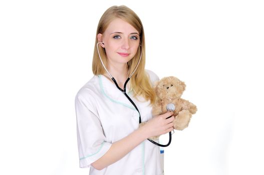 Female pediatrician examining a teddy bear with stethoscope. Medical concept.







Female pediatrician examining a teddy bear with stethoscope