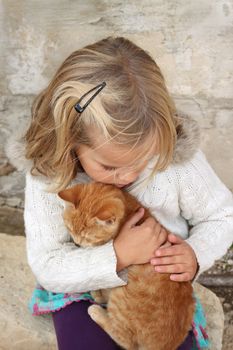 5 year old girl holding a cat