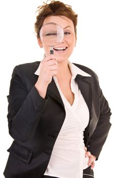 Attractive smiling business woman looking into a magnifying glass isolated