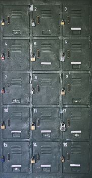 Old, rusty school locker with labels and padlocks