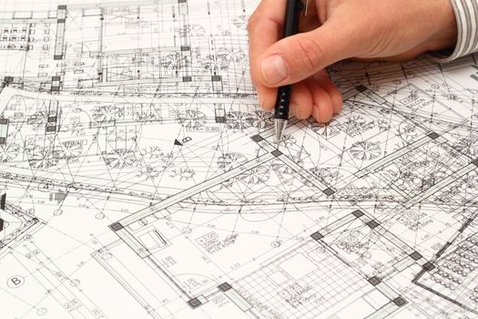 architect searching for construction solution over a very messy blueprint full of ideas