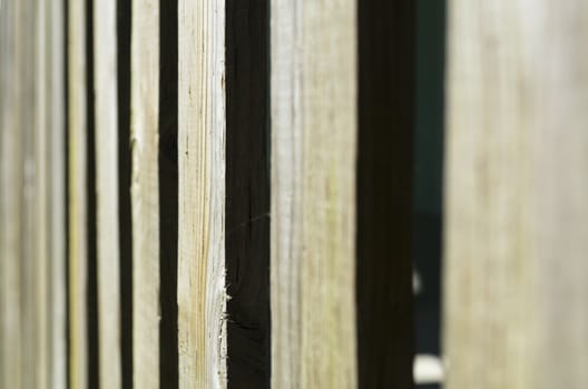 Close-up of thick and unpainted wooden fence