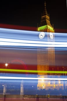 Light trails passing by Big Ben (Houses of Parliament).  The London Eye is in the background.