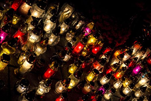 All Saints' Day at a cemetery in Poland - flowers and light candles to honor the memory of deceased relatives.