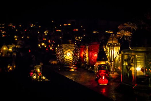 All Saints' Day at a cemetery in Poland - flowers and light candles to honor the memory of deceased relatives.