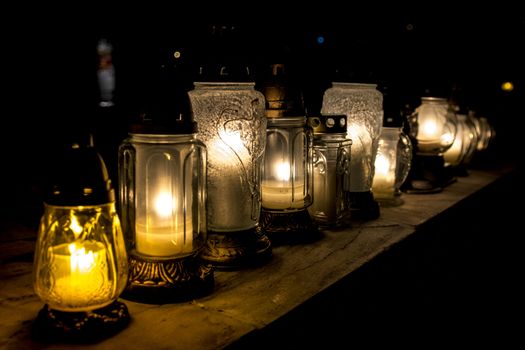 All Saints' Day at a cemetery in Poland - flowers and light candles to honor the memory of deceased relatives.