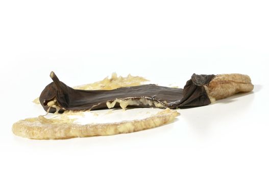 Closeup of smashed over ripe black banana on white