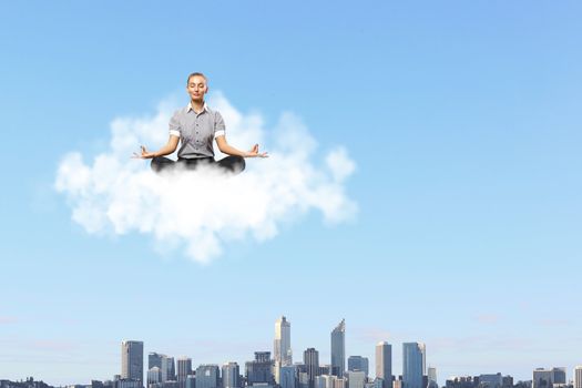 Businessman meditating sitting on the white cloud