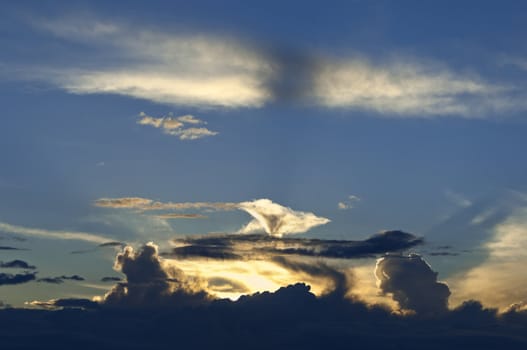 Dramatic sunburst through cumulus clouds in the evening