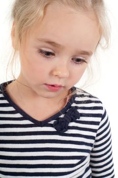 Studio portrait of little cute girl in striped top