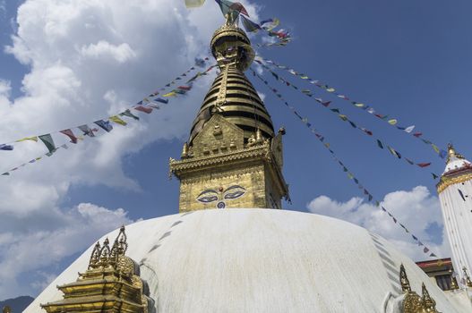 temple of swayabhunath in kathmandu, nepal with clouds and blue sky  in background