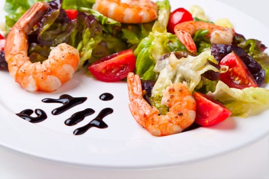 Shrimp salad on white plate close up