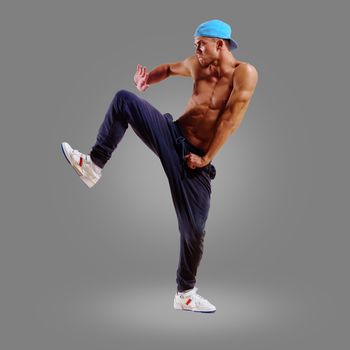 dancer of hip-hop on a gray background , motion