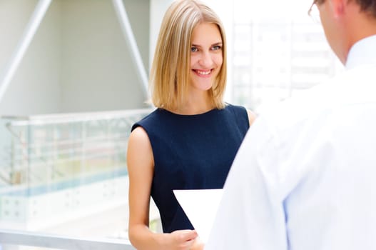 male and female entrepreneurs working together, discuss reports