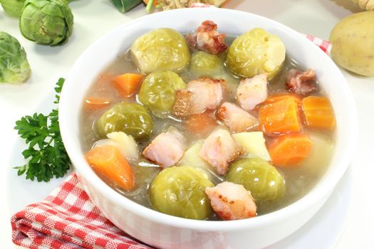 a bowl of Brussels sprouts stew with vegetables and bacon