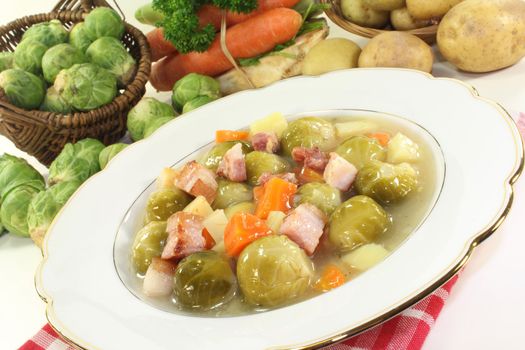 a plate of Brussels sprouts stew with vegetables and bacon