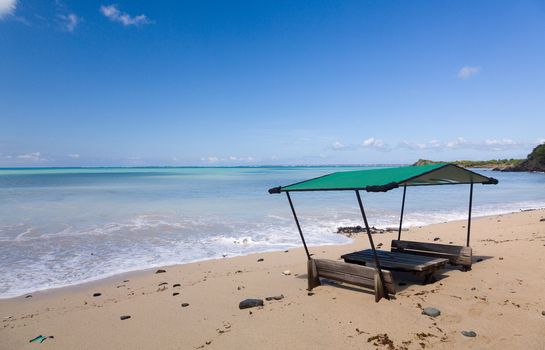 Sand swamps and buries table and chairs at bar on Friar's beach St Martin Sint Maarten