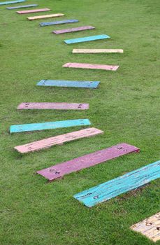 Colorful wooden pathway steps lead to the backyard