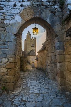 Castle of Beynac, Dordogne, France, shot through a stone archway