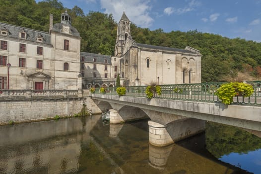 Abbey in the French village of Brantome with river flowing by
