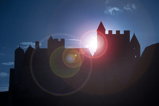 Medieval Beynac castle in France backlit by the sun