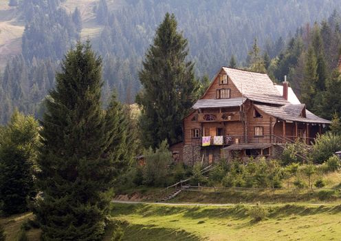 A small chalet on the green hill, Carpathian landscape