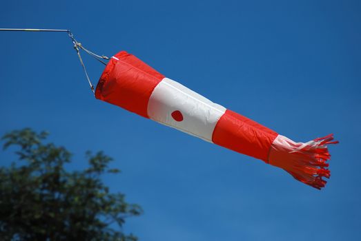 Wind indicator at the airport with blue sky in the background