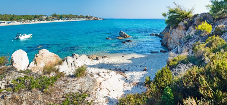 Beautiful rocky beach in Greece, wonderful nature, blue water, pine trees