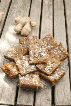 homemade ginger cookies over wooden table with fresh ginger root