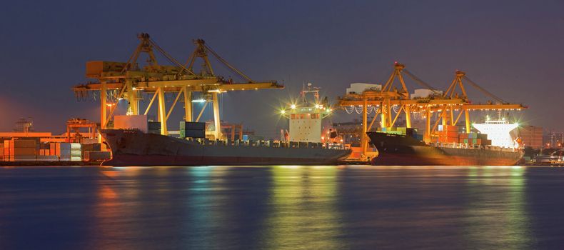 Panorama of Container Cargo freight ship with working crane bridge in shipyard at dusk for Logistic Import Export background