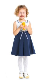 Happy little girl drinking orange juice. Isolated over white background.