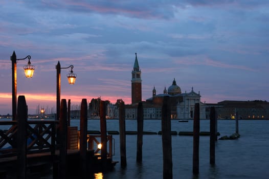 Romantic view of Venice with two lampposts in the early morning and San Giorgio Maggiore at the background.